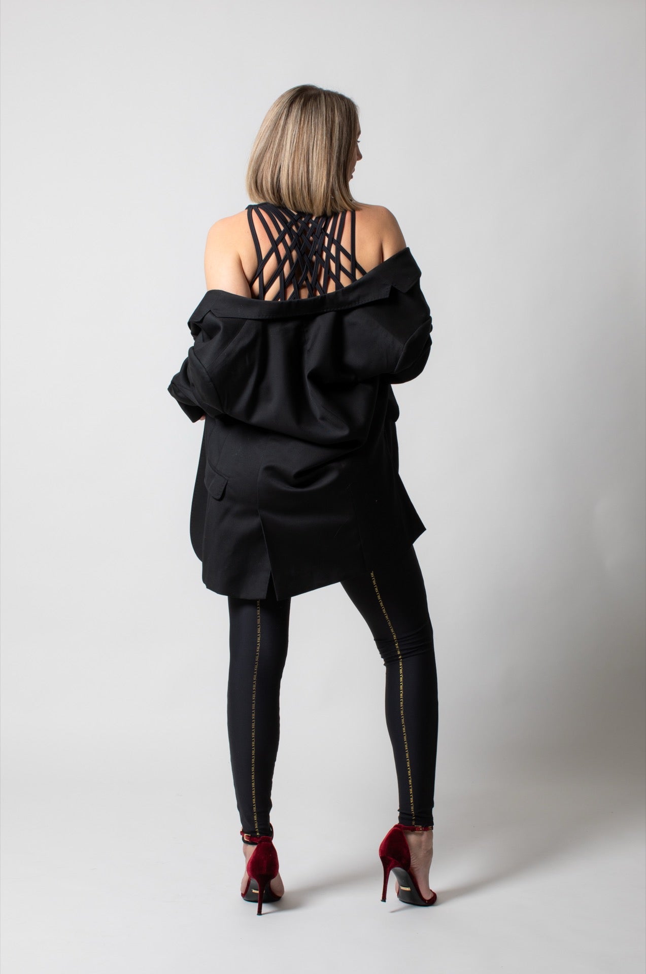 SILA kombinezon in neutral fabric with long sleeves and a fitted waist, featuring a front zipper and stylish design.