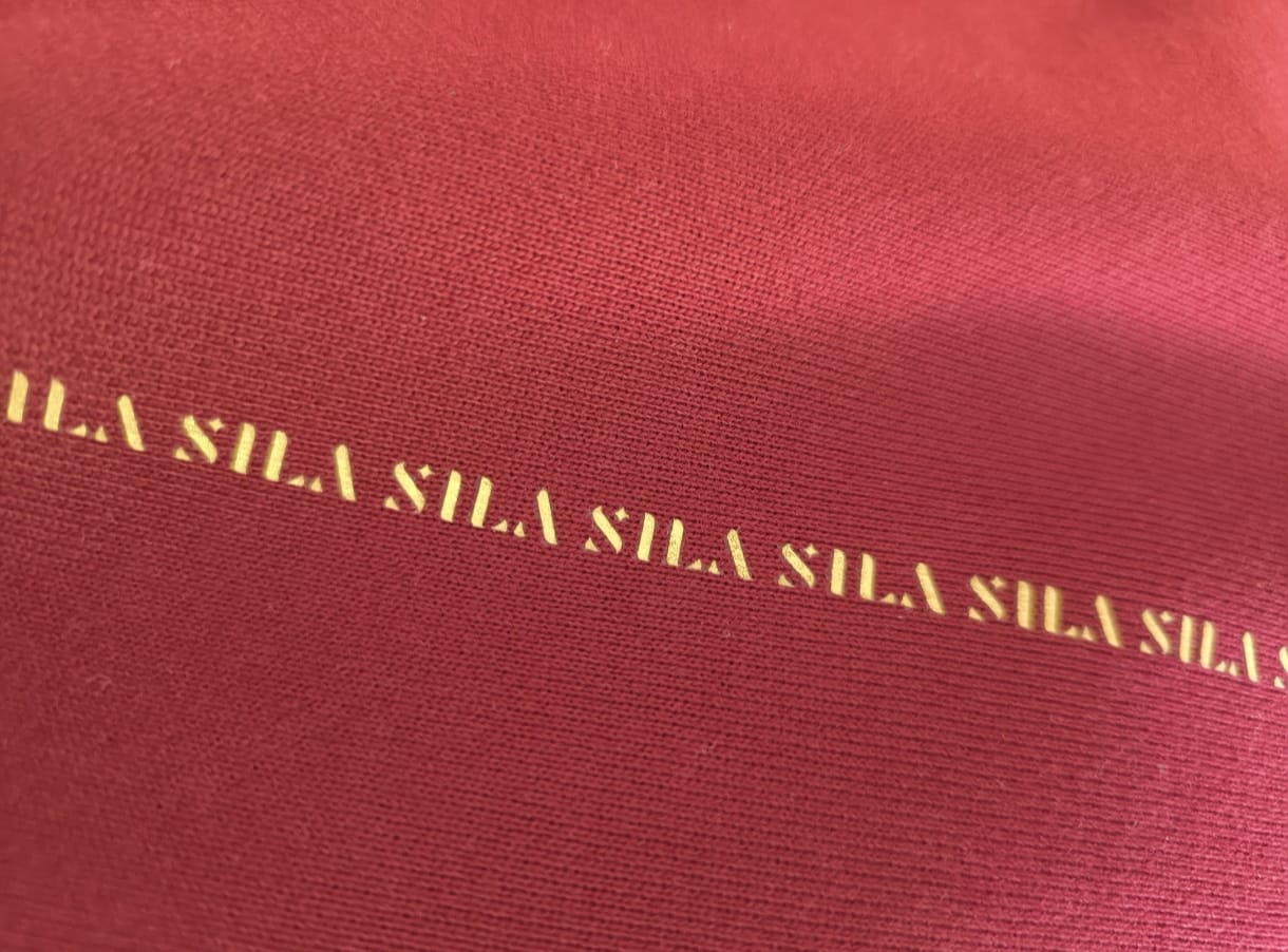 SILA Hudica with adjustable strap, lightweight fabric, and logo detail, designed for outdoor activities and casual wear.