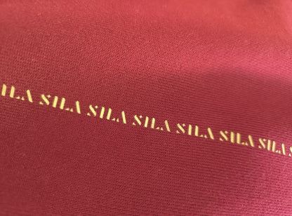 SILA Hudica with adjustable strap, lightweight fabric, and logo detail, designed for outdoor activities and casual wear.